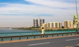 Sudanese man crossing bridge