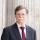 Profile picture of Paul Aplin OBE, a man wearing glasses and dressed in a suit.