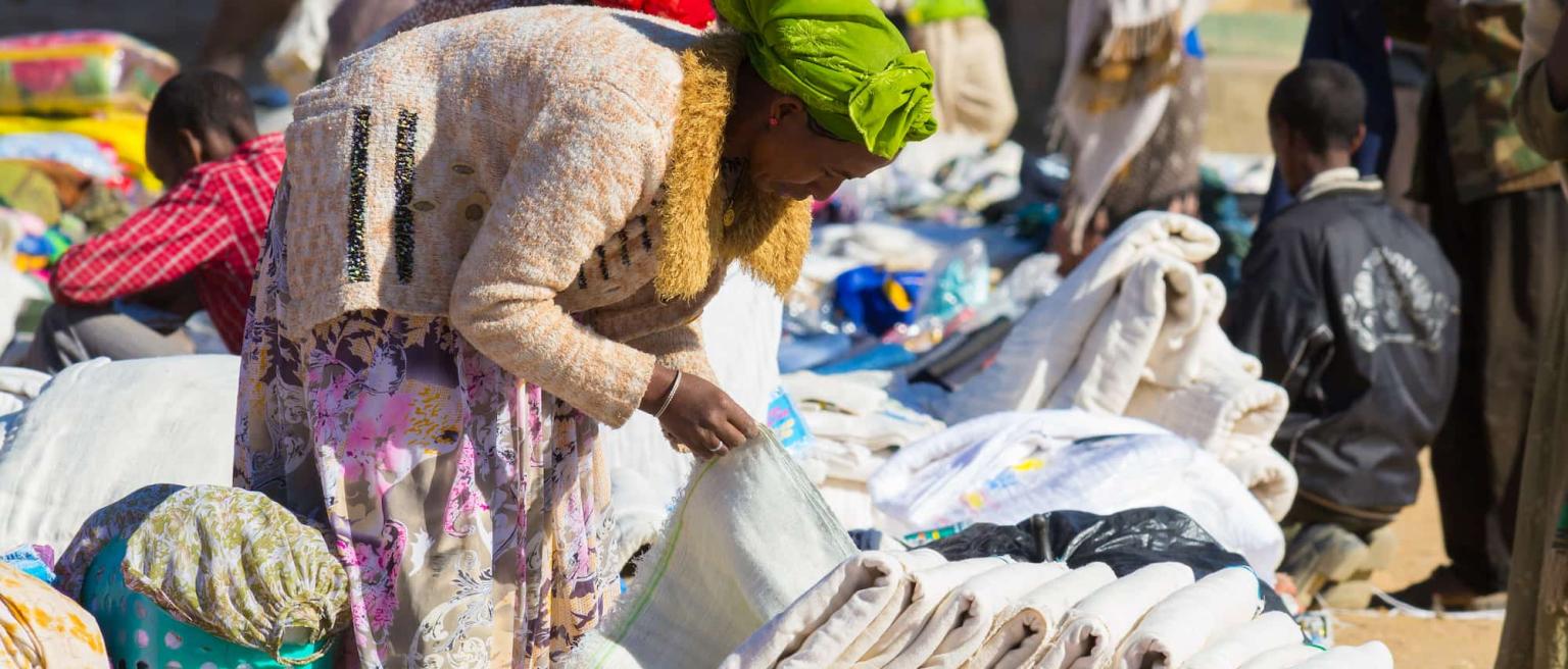 Woman looking at products at a textile market stall in Ethiopia where Chinese imports are helping boost manufacturing. 