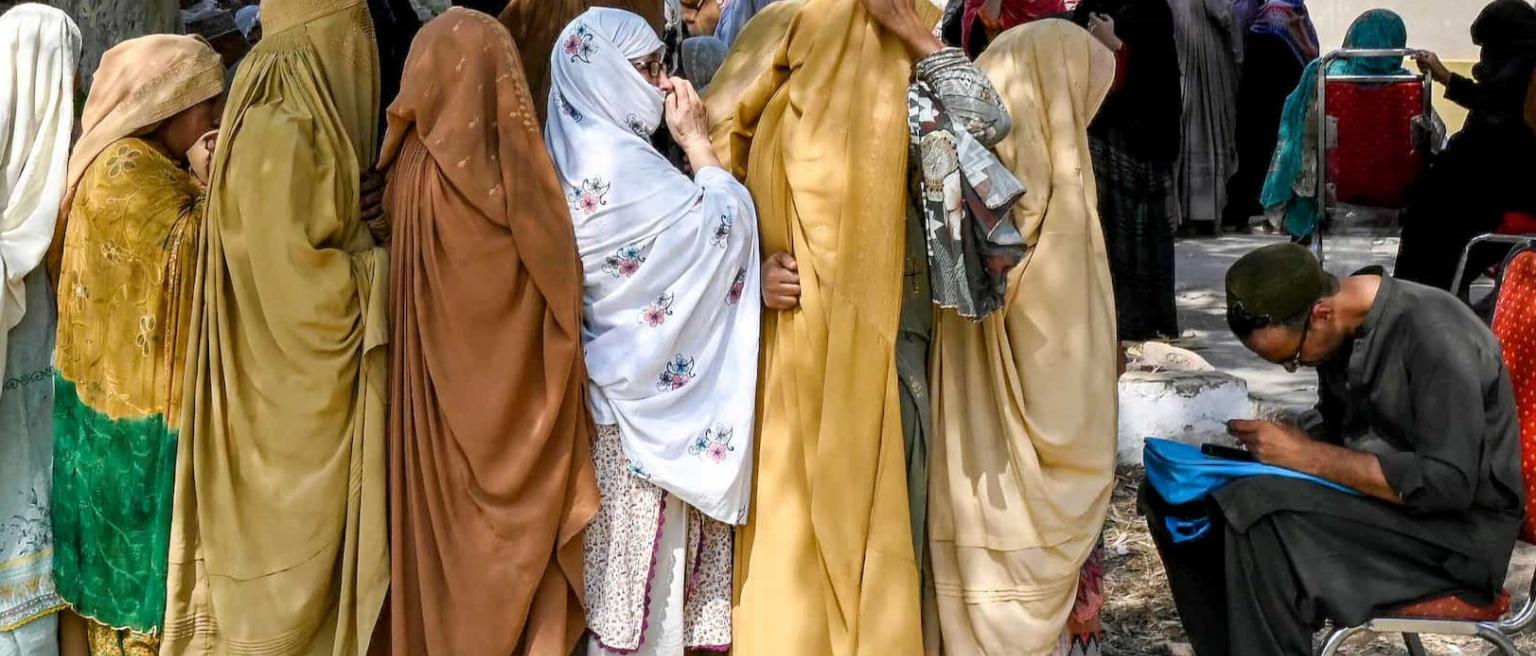 Women stand in queues to receive financial aid under the Benazir Income Support Programme, in Peshawar, Pakistan