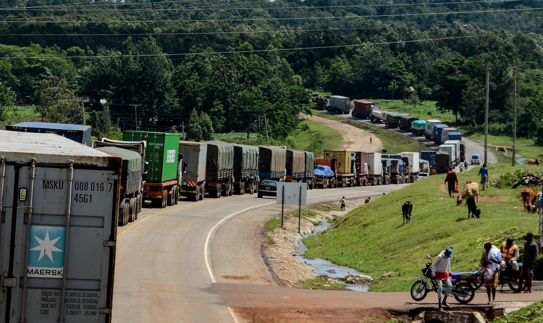 Trucks wait in a line on the road to enter Uganda in Malaba