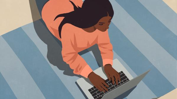 High angle view of woman laying on floor working at laptop. Photo credit: Malte Mueller / fStop via Getty Images.