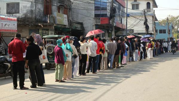 Long queues of citizens wait to register for new voter identity cards at the District Election Office in Sunsari, Nepal