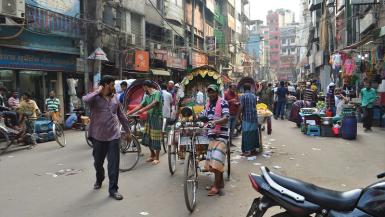 busy street in Dhaka. people riding tuk-tuks. Photo taken by Francisco Anzola