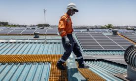 Technician walking on solar roof in Kenya