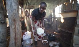 Woman preparing food (nshima and chicken) in Ng'andu Village (Zambia)