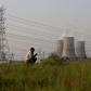 People are seen near the National Thermal Power Corporation (NTPC) Ltf. plant in Gautam Budh Nagar district of Ghaziabad, India on May 05, 2022.