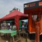 A woman dressed in orange withdraws money at an Orange Money cashier booth
