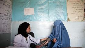 10 May 2012, Tajikhan Village, Jabalseraj District Parwan Province, Afghanistan: Muzhda Malikzada (29) a mid wife at the Sar-e-Hause medical health clinic checks patient. Photo credit: Graham Crouch / World Bank.