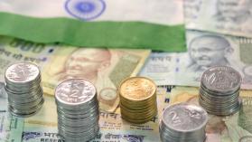 Closeup view of Indian rupee currency notes and coins. Photo credit: jayk7 / Moment via Getty Images.