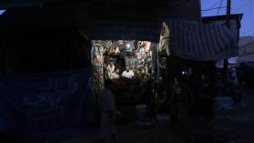 A Yemeni vendor uses a lantern to light his shop at a market in the capital Sanaa in 2015. Photo by Mohammed Huwais/AFP via Getty Images.