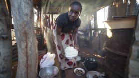 Woman preparing food (nshima and chicken) in Ng'andu Village (Zambia)