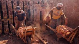 Workers Placing Bricks in Wheelbarrows, Pakistan