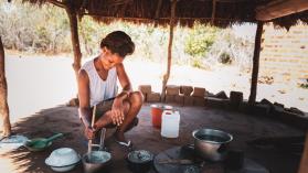 A woman cooking in a hut in Zambia. Credit: GCShutter/E+ via Getty Images