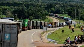 Trucks wait in a line on the road to enter Uganda in Malaba