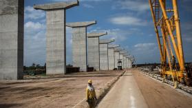 A worker stands at the Catembe side of the construction site of the Maputo-Catembe Bridge