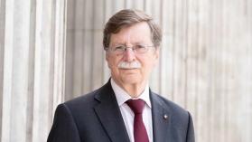 Profile picture of Paul Aplin OBE, a man wearing glasses and dressed in a suit.