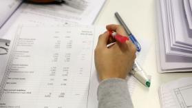 Person working on tax systems on paper with a pen in hand, doing accounting. Credit: LSE / Nigel Stead
