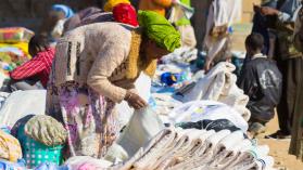 Woman looking at products at a textile market stall in Ethiopia where Chinese imports are helping boost manufacturing.