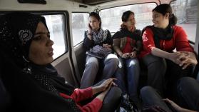 Women employed in Pakistan face different challenges due to job references. They are pictured riding a vehicle to ensure safe transportation to work.