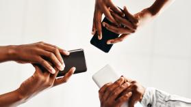 A digital town hall using mobile phones was used in Sierra Leone to boost citizen participation as illustrated by an image of hands holding mobile phones.