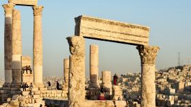 Youth and women are essential to unlocking Jordan's labour market potential, illustrated by a photo of people, many of whom are young people and women, at sunset by the Amman citadel.