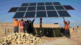 An image of solar panels being constructed by a group of male construction workers in Ethiopia
