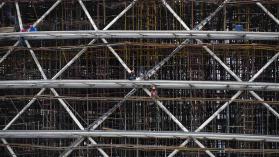 An image of construction workers working together on a large building site in Rwanda