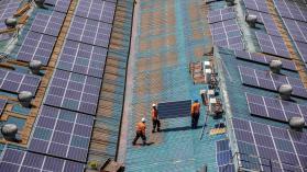 An image os solar panel installation in Somalia where multiple construction workers are carrying the panels. 