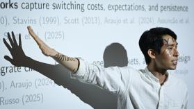 Allan Hsiao with arm outstretched over presentation slide at LSE Environment Week 2025.