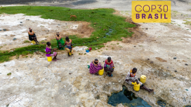 Women collecting water in plastic containers from a volcanic spring, Turkana region, Kenya (Credit: Martin Harvey via GettyImages)