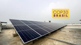 Blue Photovoltaic Solar Panels installed on a building rooftop. Rooftop Solar Plant - stock photo