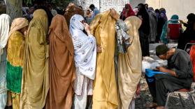 Women stand in queues to receive financial aid under the Benazir Income Support Programme, in Peshawar, Pakistan