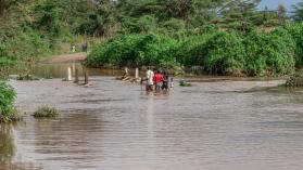 NAKURU, KENYA - 2020/04/24: People attempt to cross a section of a flooded Njoro River oblivious of the risks. Photo credits: James Wakibia / SOPA Images / LightRocket via Getty Images.
