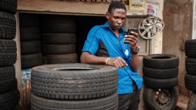 A man browses Facebook on his smart phone after the mobile internet went back online in Kampala, Uganda, on January 18, 2021. Photo credits: YASUYOSHI CHIBA/AFP via Getty Images.