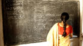 School teacher writing on a blackboard in Ngo Patang, Sambalpur, Orissa, India.