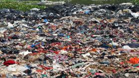Waste material from a garment factory is dumped in a canal at Savar on February 21, 2022, in Dhaka, Bangladesh. 