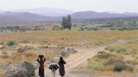 Two Bedouin women walk along a dirt road near the Yemeni town of Marib. Photo credit: Christophe Boisvieux / The Image Bank via Getty Images.