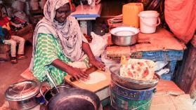 Local Woman making Pita Bread on the Food Market - stock photo