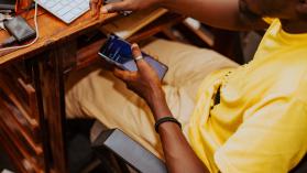 Man using mobile phone while working at home,Accra,Ghana by&nbsp;Junior Asiama / 500px Prime via Getty Images