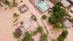 Aerial view overhead flooded houses after a cyclone and rain by fivepointsix /  iStock / Getty Images Plus via Getty Images