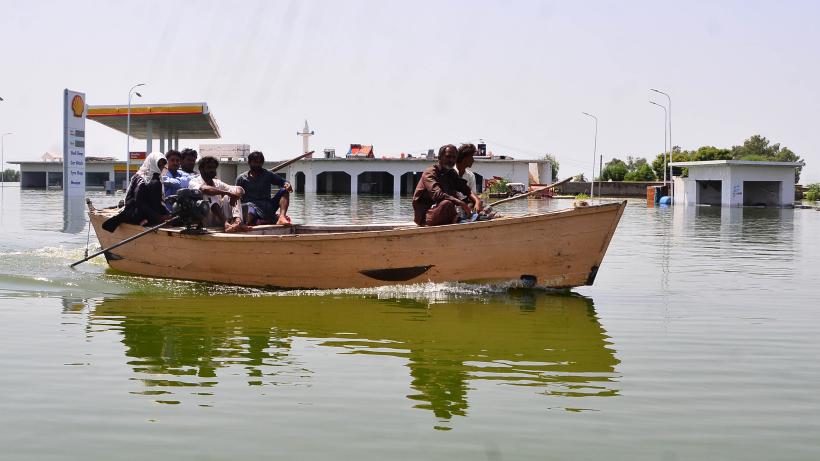Flood victims evacuated on a boat in Pakistan