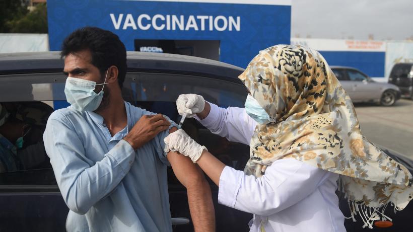 Man receives COVID-19 vaccine at drive through