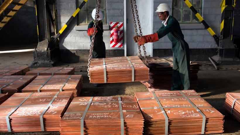 Copper is a critical mineral for clean energy. Workers in Zambia moving copper at a warehouse in Zambia to be transported to ports such as Dar es Salaam, Tanzania, and Durban in South Africa.