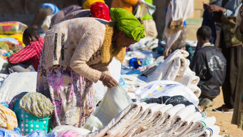 Woman looking at products at a textile market stall in Ethiopia where Chinese imports are helping boost manufacturing. 