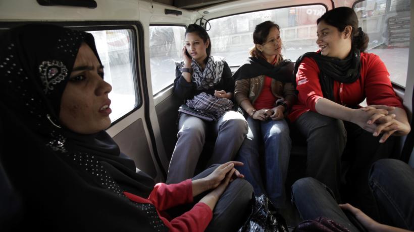 Women employed in Pakistan face different challenges due to job references. They are pictured riding a vehicle to ensure safe transportation to work.