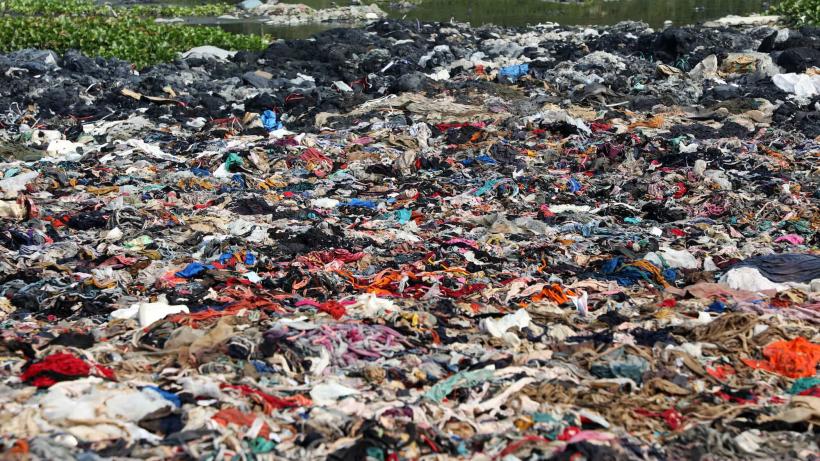 Garment waste collecting by a river in Bangladesh.