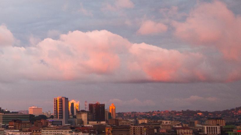 A pink sunset colorfully lightens the clouds and buildings of Kampala. Photo credit: Universal Stopping Point Photography / Moment Open via Getty Images.