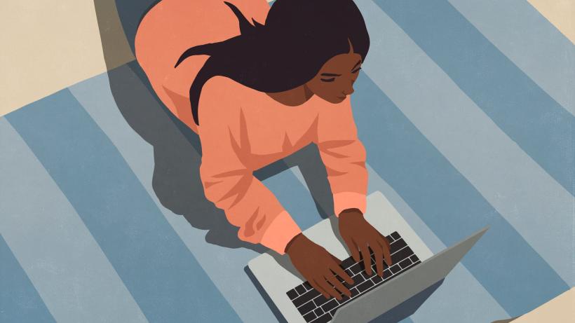 High angle view of woman laying on floor working at laptop. Photo credit: Malte Mueller / fStop via Getty Images.