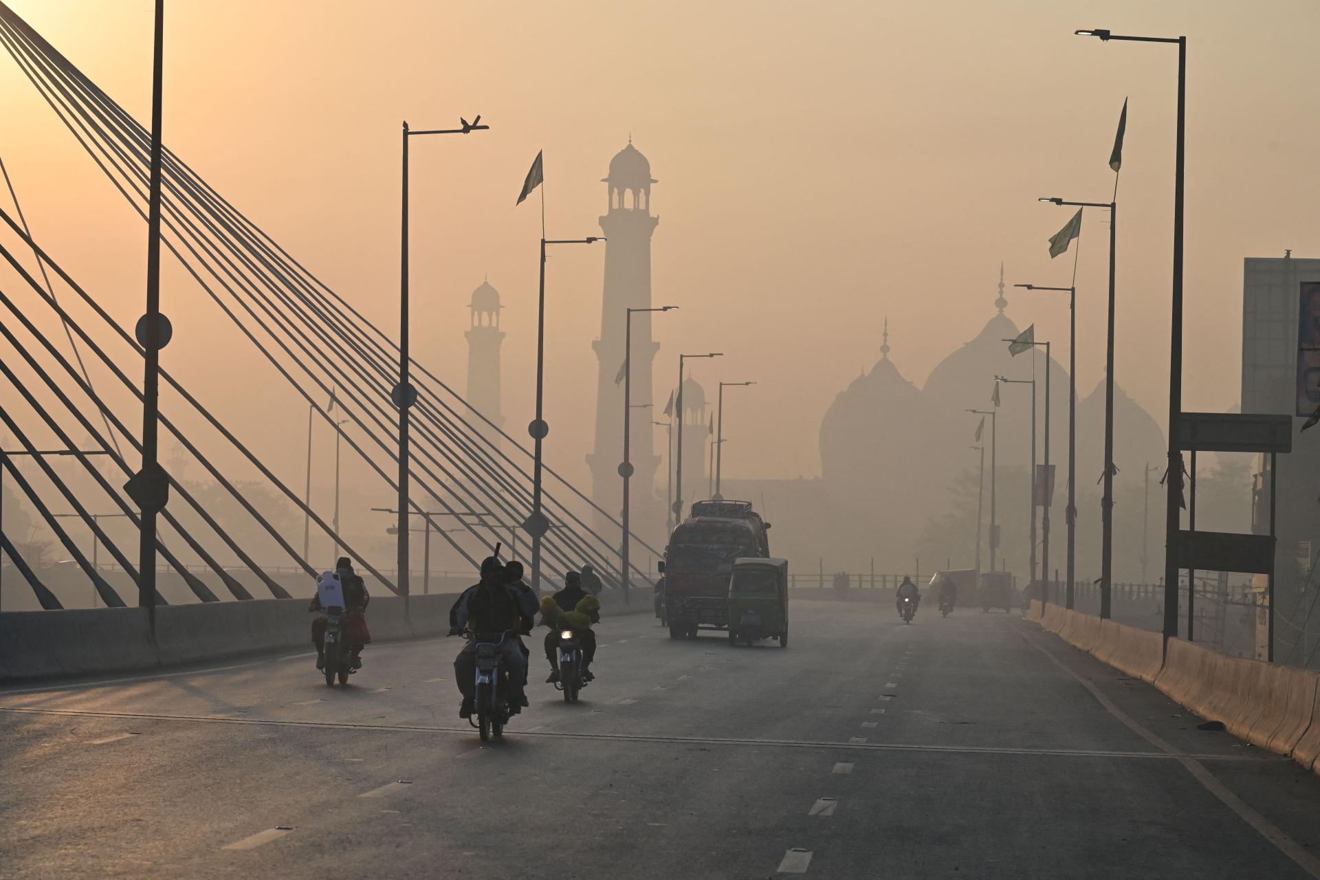 Commuters during heavy smog in Lahore